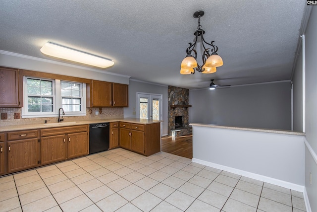 kitchen featuring a wealth of natural light, pendant lighting, kitchen peninsula, and black dishwasher