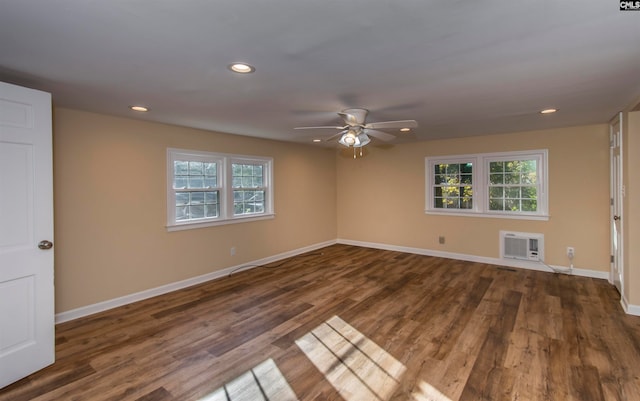 unfurnished room with a wealth of natural light, ceiling fan, dark hardwood / wood-style flooring, and a wall mounted air conditioner