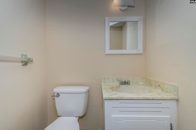 bathroom featuring toilet and vanity