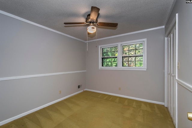 unfurnished room with crown molding, light colored carpet, a textured ceiling, and ceiling fan