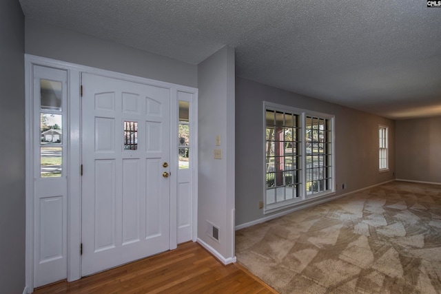 entrance foyer featuring a textured ceiling and hardwood / wood-style flooring