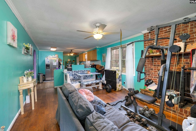 living room featuring hardwood / wood-style flooring, ceiling fan, a textured ceiling, and ornamental molding