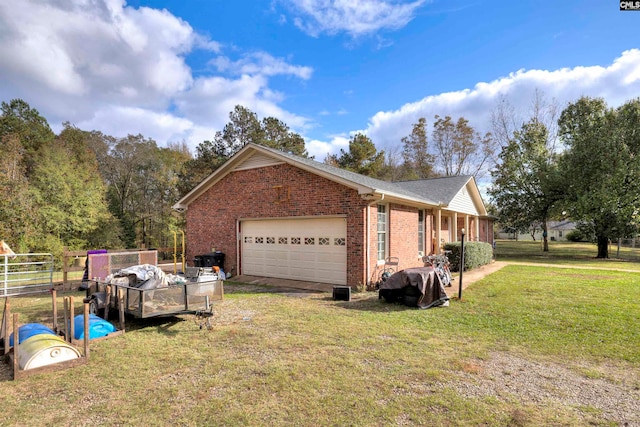 view of side of property with a garage and a lawn