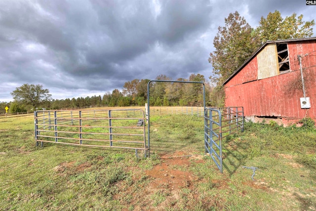 view of gate with an outbuilding and a rural view