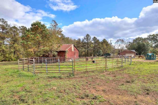 view of yard with an outdoor structure and a rural view