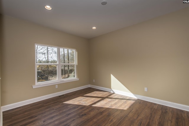 spare room with dark hardwood / wood-style flooring