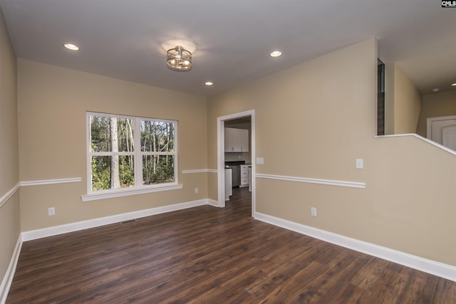 spare room with dark hardwood / wood-style flooring