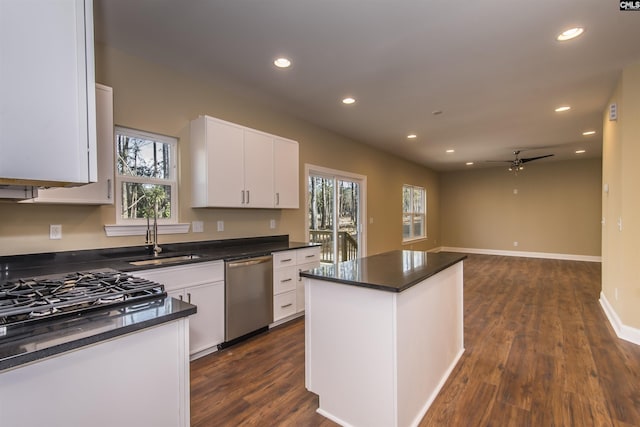 kitchen with sink, white cabinetry, dishwasher, and a kitchen island