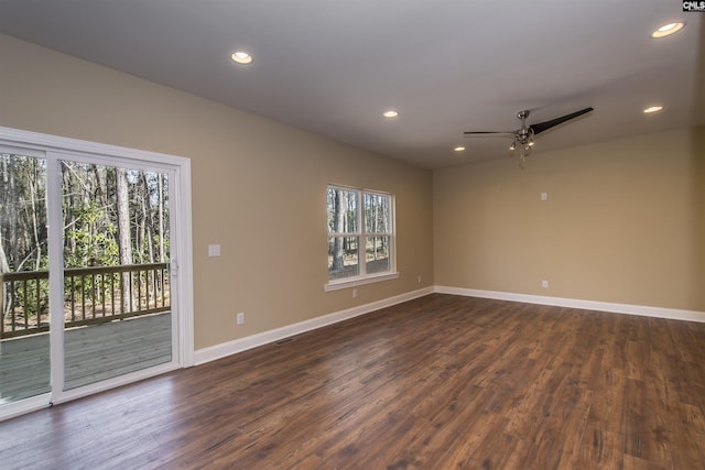 spare room with ceiling fan and dark wood-type flooring