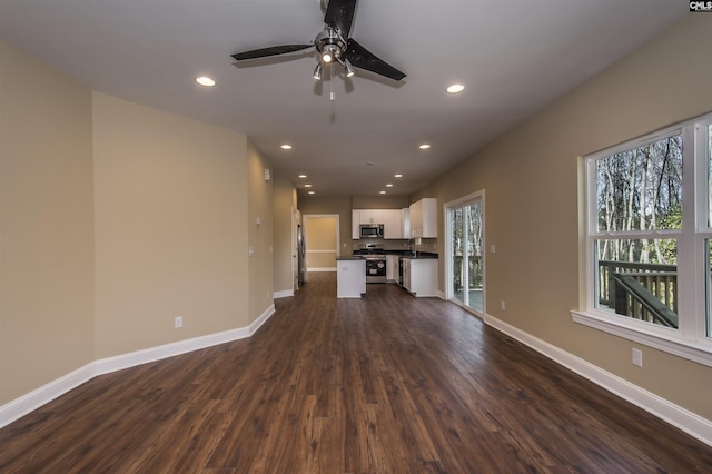 unfurnished living room with dark wood-type flooring and ceiling fan