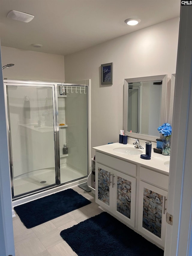 bathroom with walk in shower and vanity