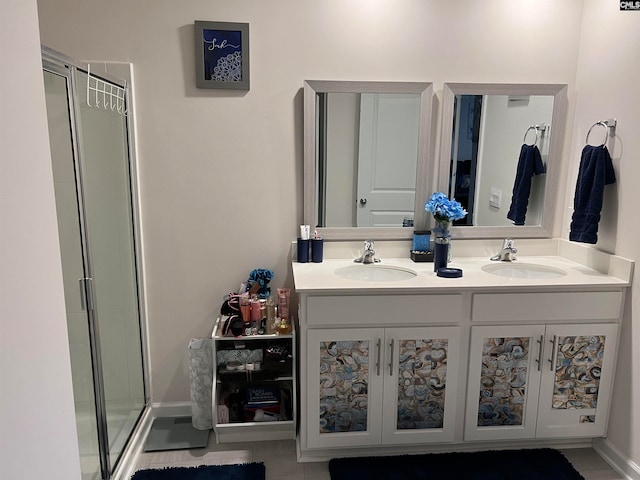 bathroom featuring a shower with shower door and vanity