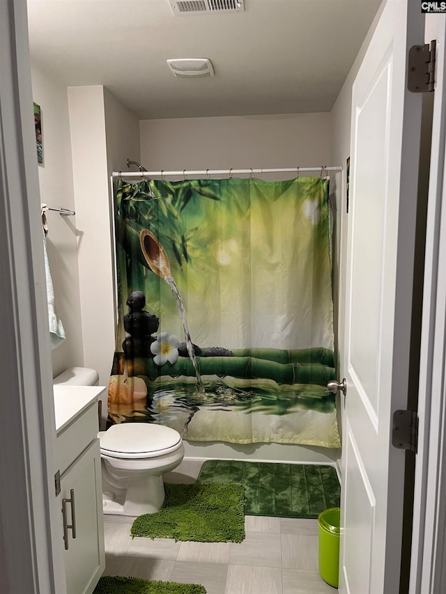 bathroom featuring curtained shower, tile patterned floors, vanity, and toilet