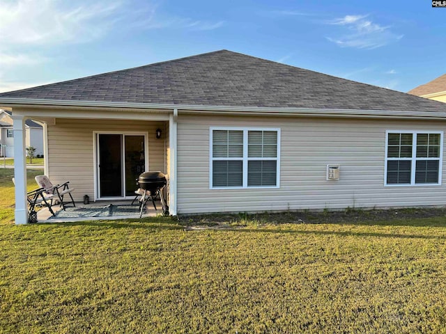 rear view of house featuring a patio and a yard