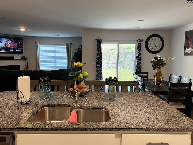 kitchen with dark stone countertops and sink