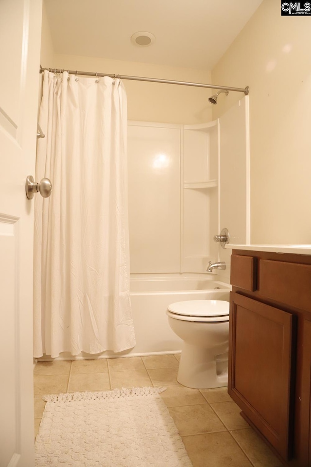 full bathroom with toilet, vanity, tile patterned floors, and shower / tub combo