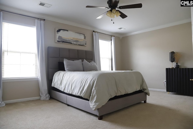 carpeted bedroom featuring ceiling fan and crown molding