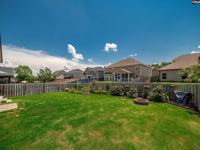 view of yard with a fire pit