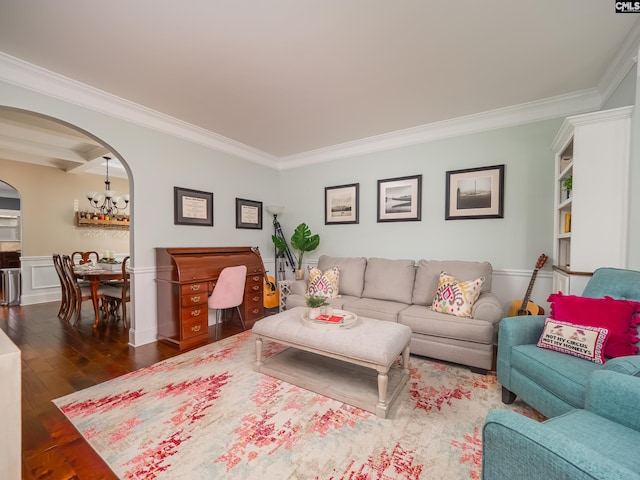 living room with a chandelier, ornamental molding, and dark hardwood / wood-style floors