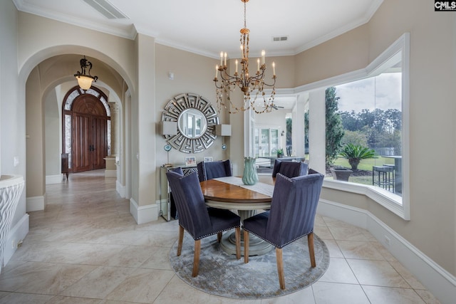 dining area featuring ornamental molding, light tile patterned floors, and an inviting chandelier