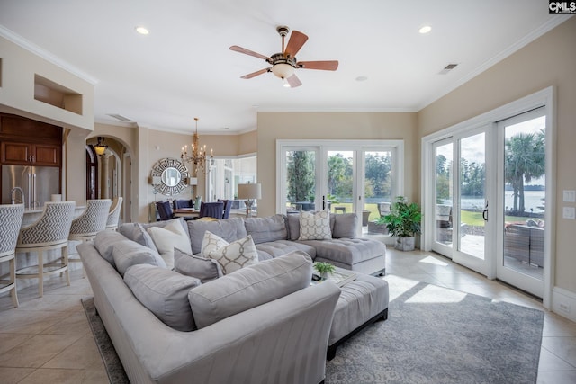 tiled living room featuring ceiling fan with notable chandelier, ornamental molding, and plenty of natural light