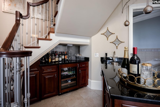 bar featuring tasteful backsplash, dark stone counters, light tile patterned floors, sink, and beverage cooler