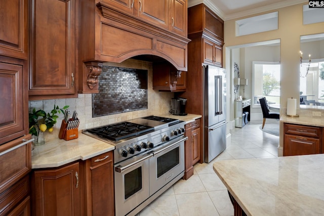 1118 Marble Arch Ct, Chapin, SC 29036 - kitchen featuring premium appliances, custom exhaust hood, decorative backsplash, ornamental molding, and light tile patterned flooring