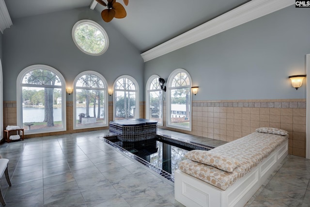 1118 Marble Arch Ct, Chapin, SC 29036 - bathroom with high vaulted ceiling, a ceiling fan, tile walls, a wainscoted wall, and a water view