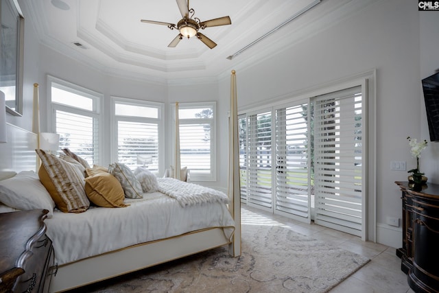 tiled bedroom featuring access to exterior, multiple windows, ceiling fan, and a tray ceiling