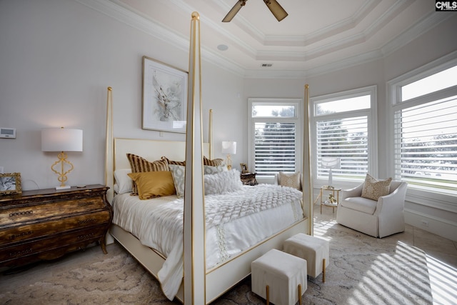 bedroom with ceiling fan, a raised ceiling, and crown molding