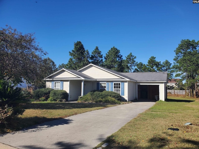 single story home featuring a front lawn and a garage