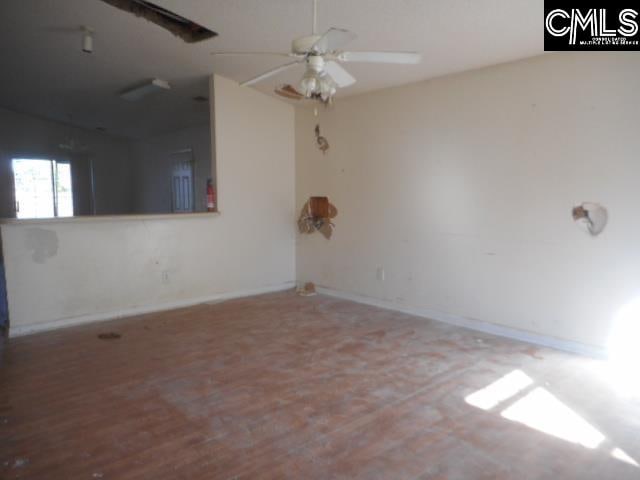 empty room featuring wood-type flooring and ceiling fan