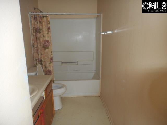 full bathroom with shower / bath combo, vanity, and toilet