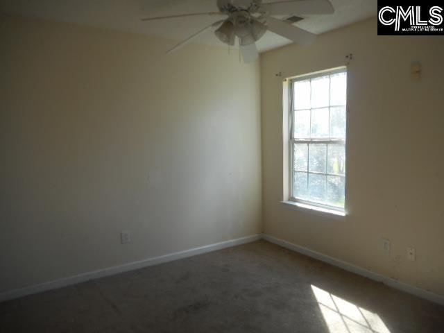 unfurnished room with ceiling fan