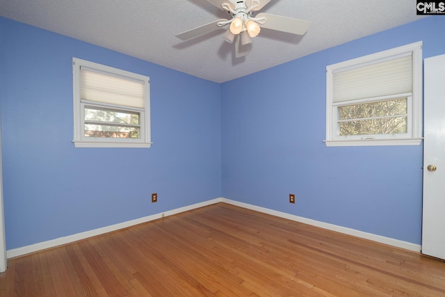 empty room featuring light wood-type flooring, a textured ceiling, and ceiling fan