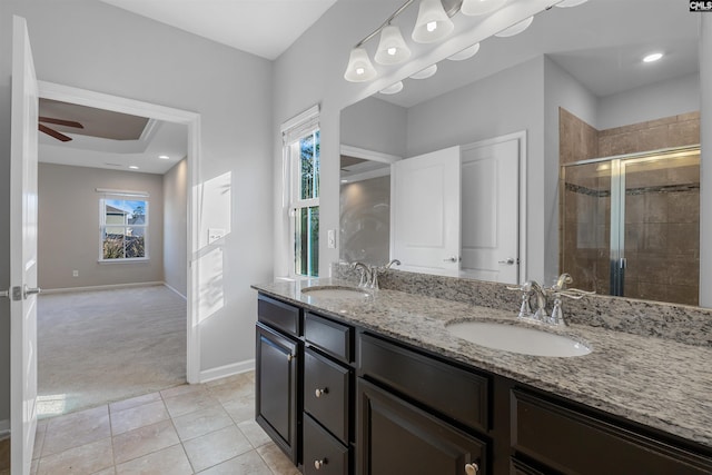 bathroom featuring tile patterned flooring, an enclosed shower, vanity, and ceiling fan