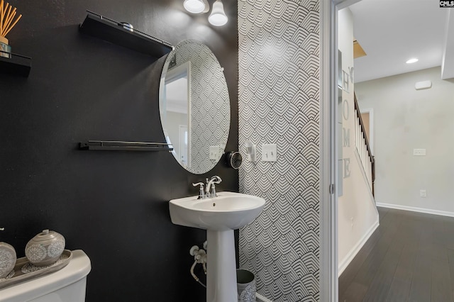 bathroom featuring hardwood / wood-style flooring and toilet