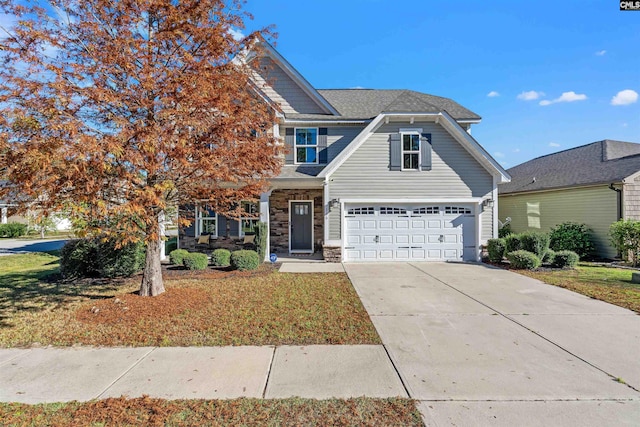 view of front of house with a garage and a front lawn