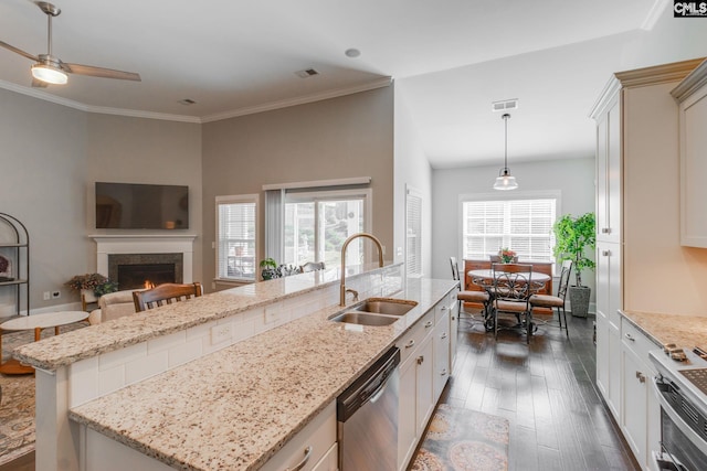 kitchen featuring sink, hanging light fixtures, dark hardwood / wood-style flooring, an island with sink, and appliances with stainless steel finishes