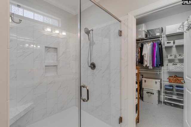 bathroom with crown molding and a shower with shower door