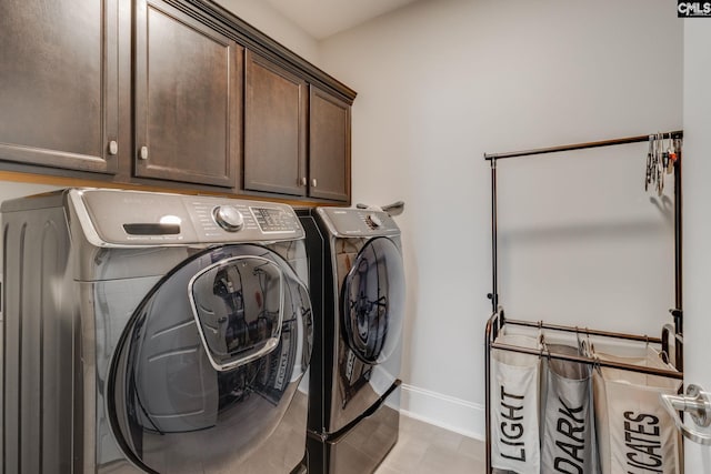 laundry area with independent washer and dryer and cabinets