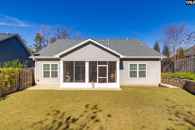 back of house with a lawn, a patio area, and a sunroom