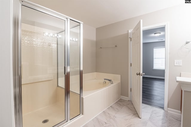 bathroom featuring hardwood / wood-style floors and independent shower and bath