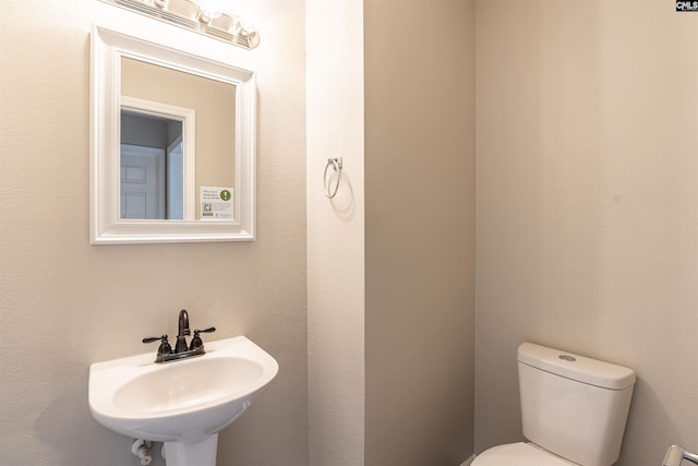 bathroom featuring toilet and sink