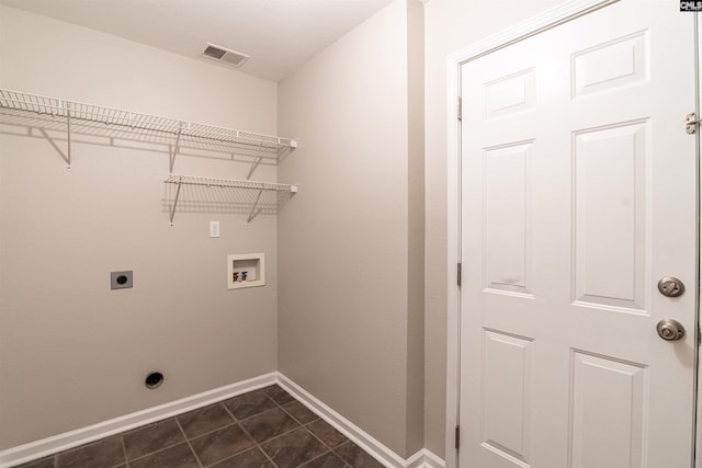 laundry area featuring electric dryer hookup, washer hookup, and dark tile patterned flooring