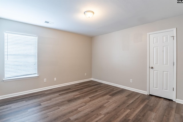 spare room with dark hardwood / wood-style floors