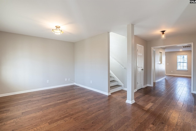 unfurnished room with dark wood-type flooring