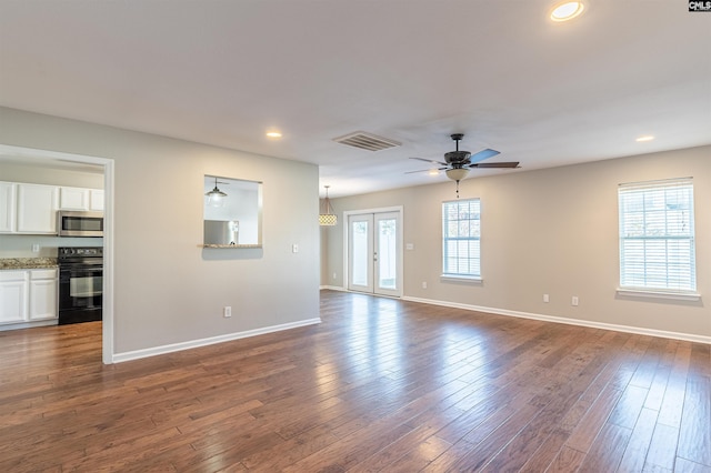 unfurnished living room with ceiling fan, dark hardwood / wood-style flooring, and french doors