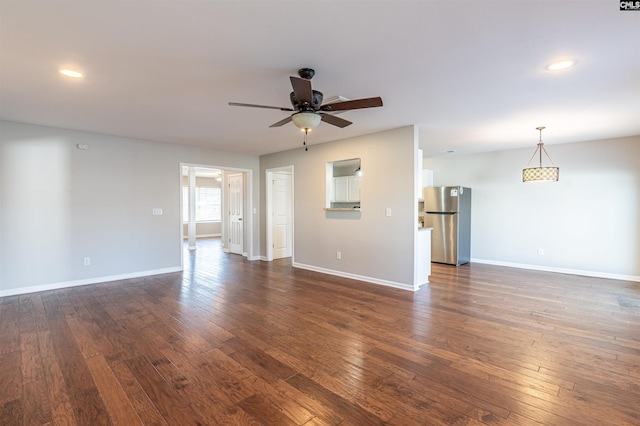 unfurnished living room with ceiling fan and dark hardwood / wood-style flooring