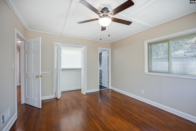 unfurnished bedroom featuring ceiling fan, crown molding, and dark hardwood / wood-style floors